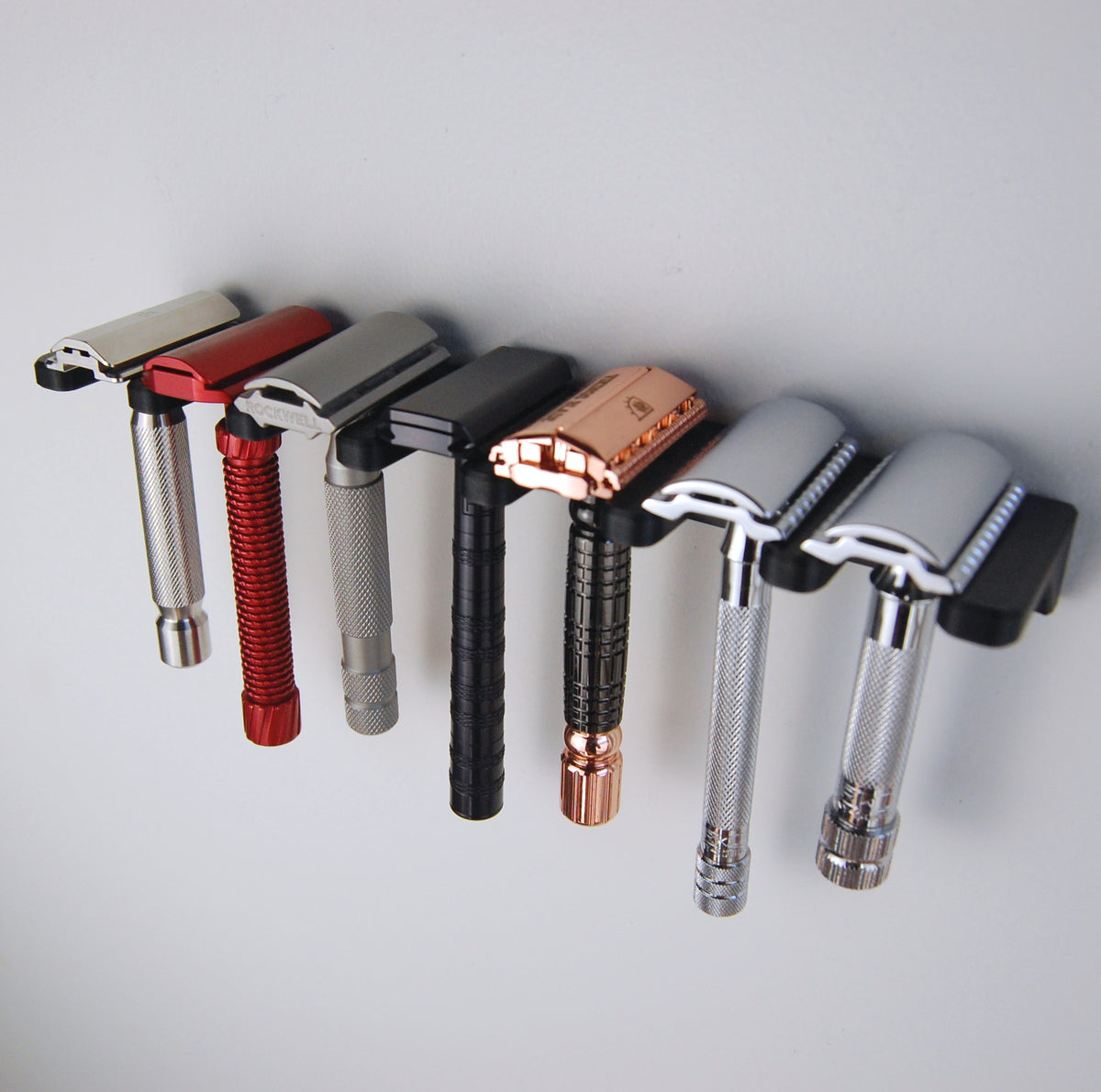 7 slot razor garden wall mount on white wall with 7 razors displayed.