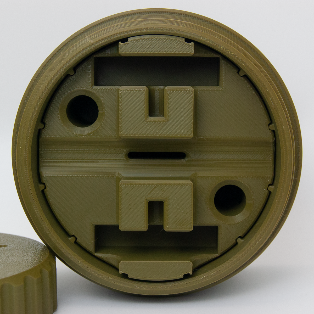 Army Green UFO Razor capsule on a white background.