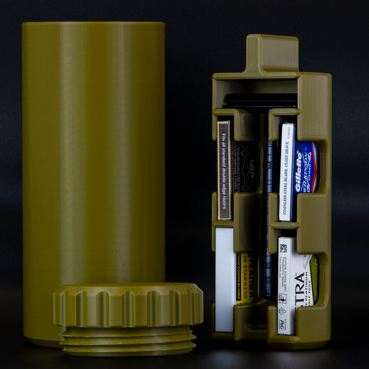 Army green, Olive Drab capsule razor case with black henson razor on a black background.