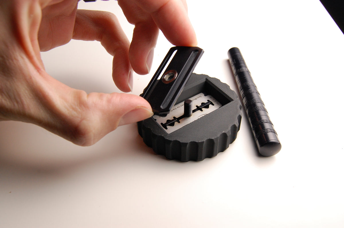 Henson Blade Installation and Removal Tool in use, with the Henson razor head being attached to the handle inside the tool.