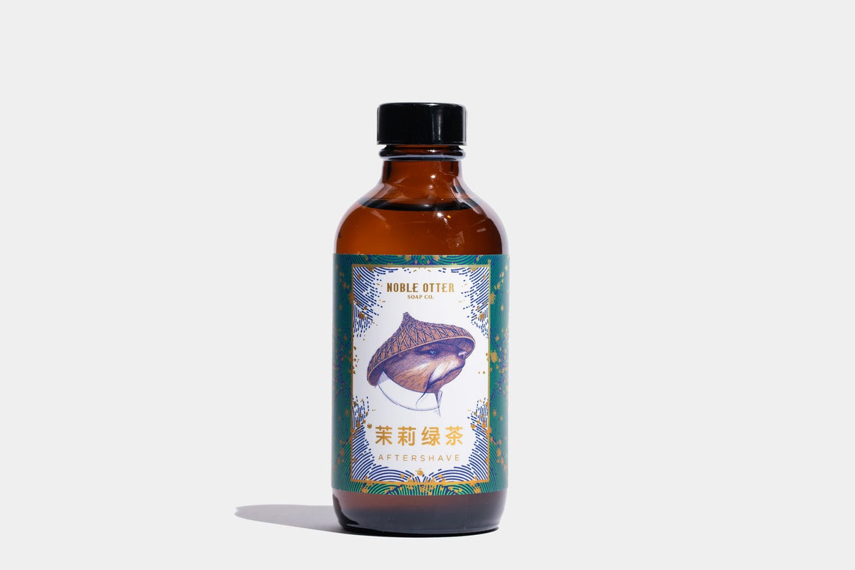 Bottle of herbal tea inspired after shave with a colorful label on a white background