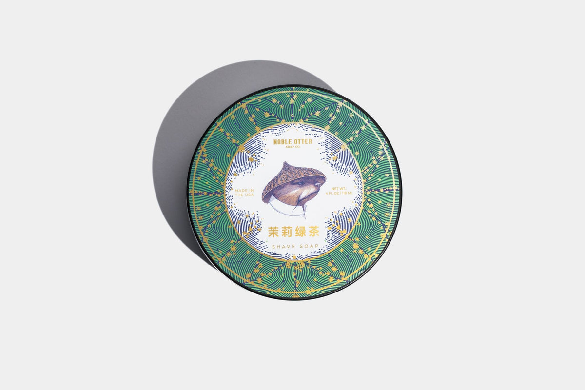 Nobel Otter shave soap tub with decorative green boarder on a white background.