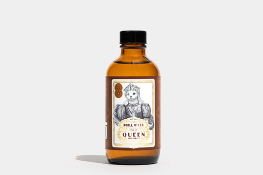 Bottle of 'Queen' aftershave on a white background