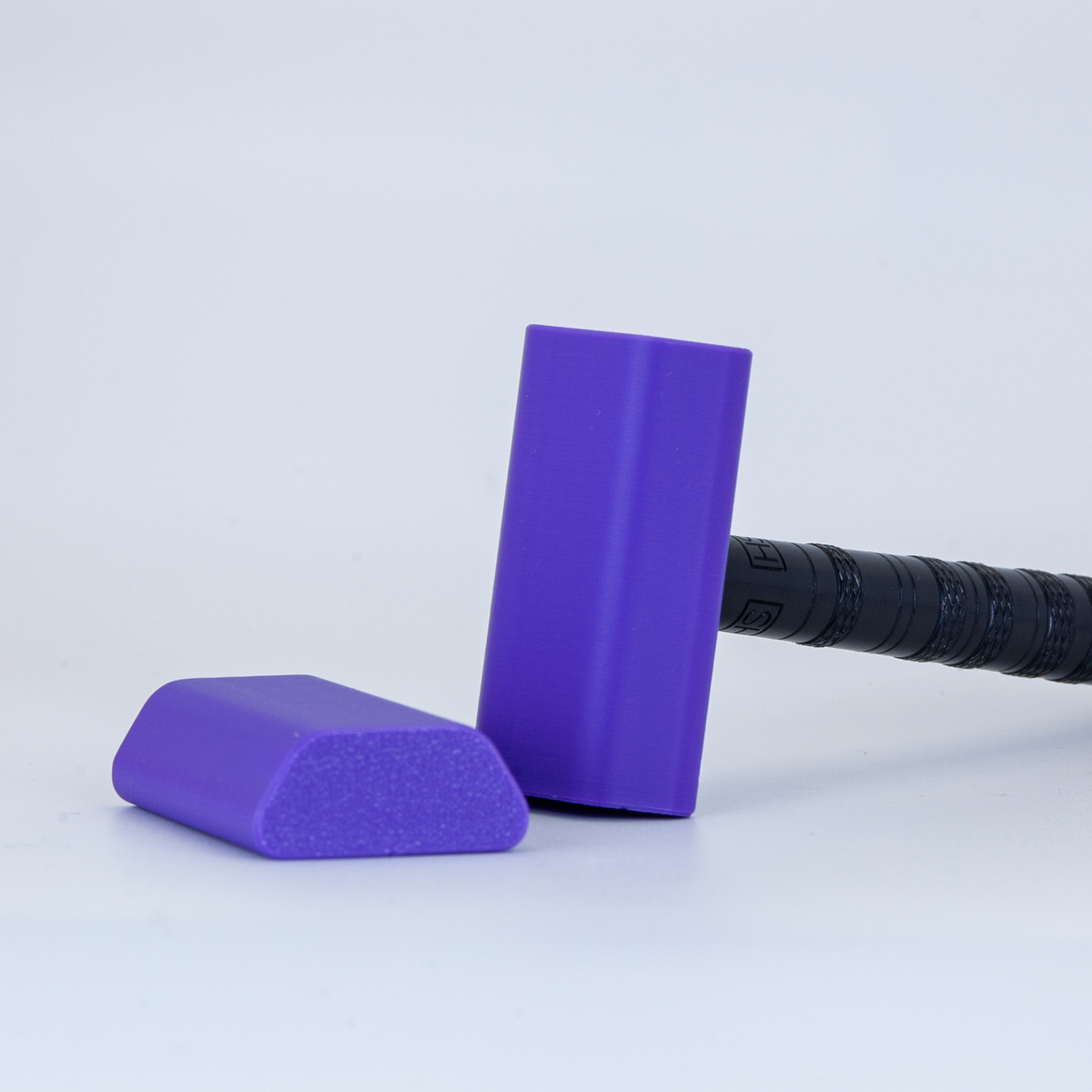 Purple Henson cover on a black henson razor on a white background