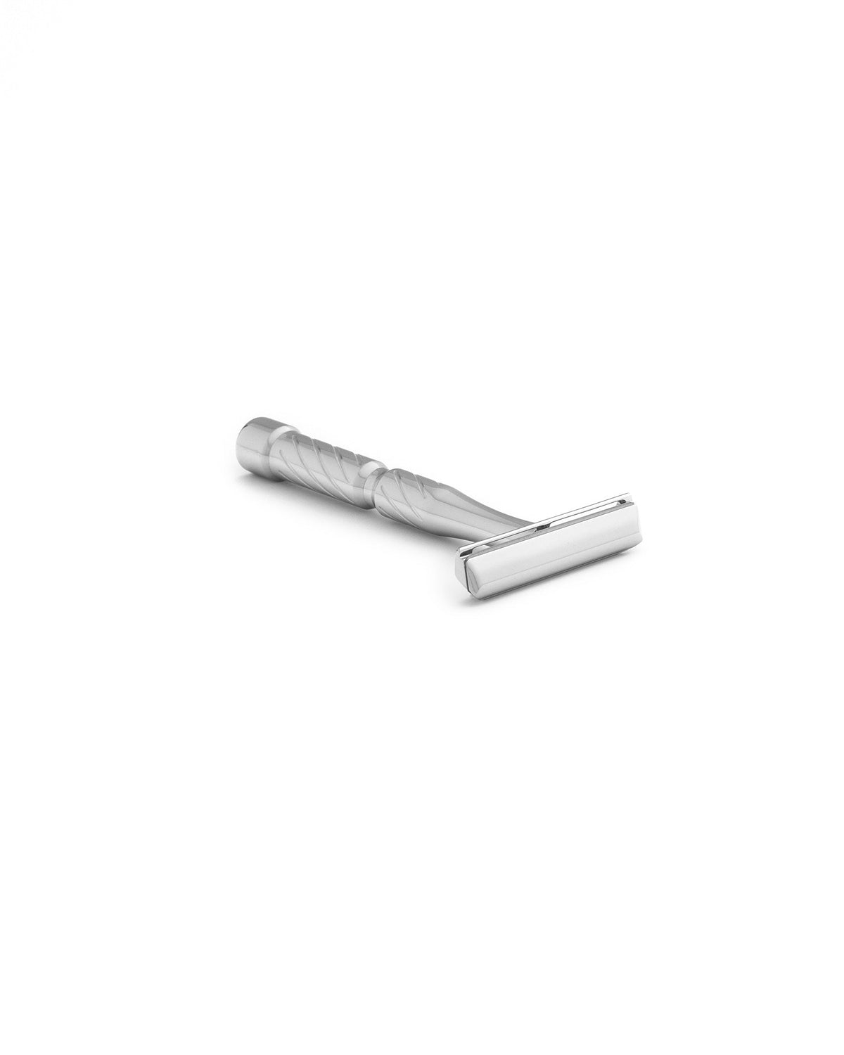 Silver chrome double-edge safety razor with spiral-textured handle, lying on its side on a white background