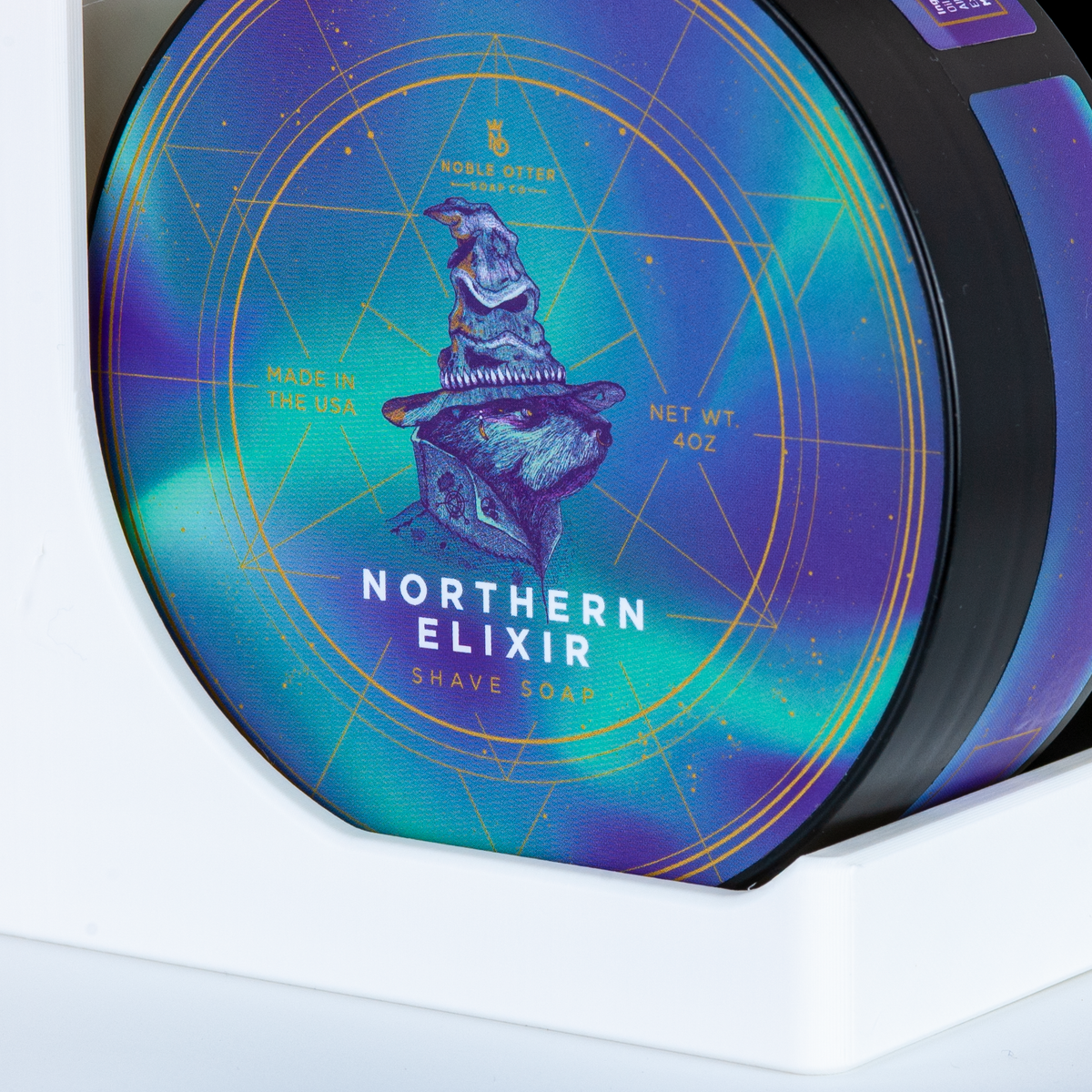Northern Elixir shave soap packaging with a blue and purple gradient label.