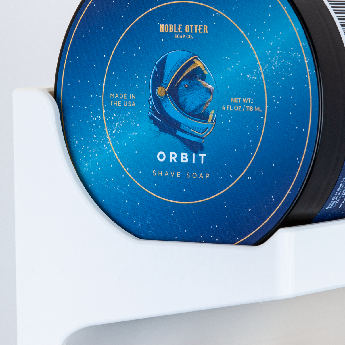 Shave soap container with 'Noble Otter' branding and 'Orbit' design on a white background