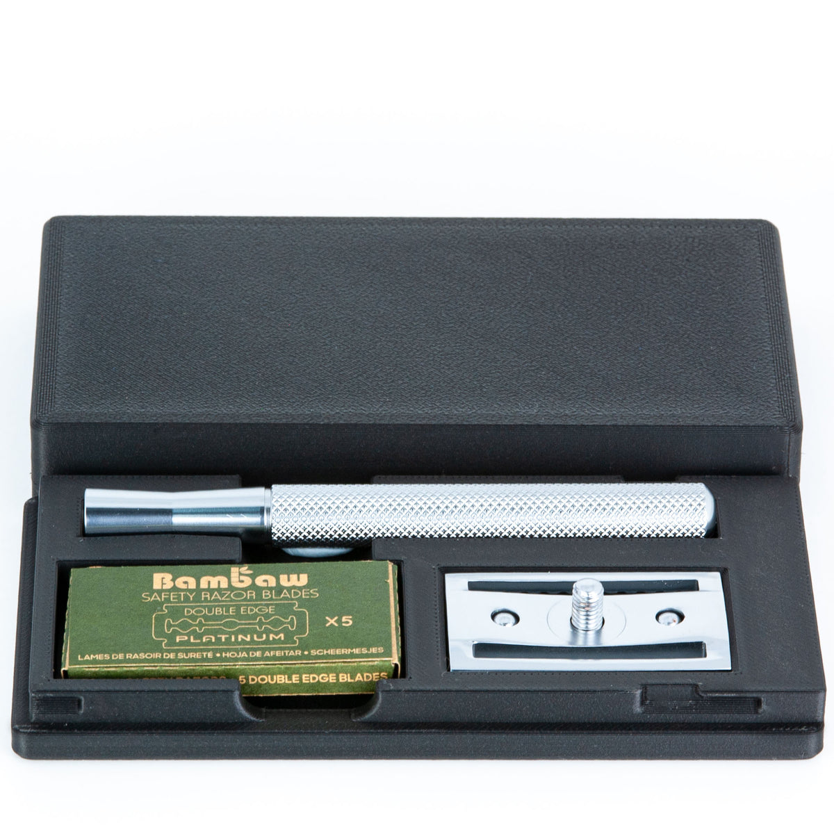Bambaw razor travel case open at an angle with chrome razor handle, Bambaw blades box, and chrome baseplate inside