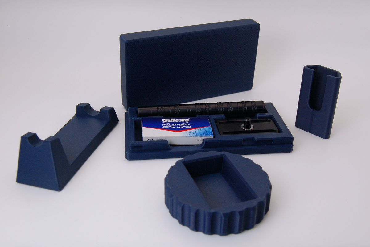 Henson razor bundle in navy blue on a white background.  Includes Henson Case, Henson Cover, razor stand, razor refueler. Razor not included.