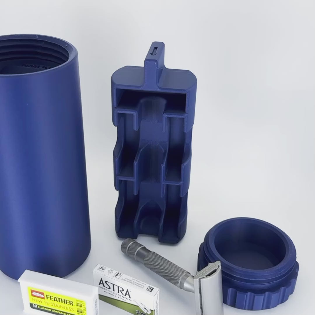 Video: loading a Navy Blue Capsule. A razor and two blade boxes click into the insert, the insert slides into the tube, and the cap screws closed