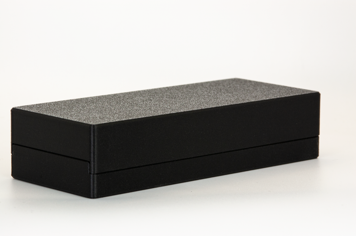Closed black Razor Blade Box Travel and Storage Case, angled view on white