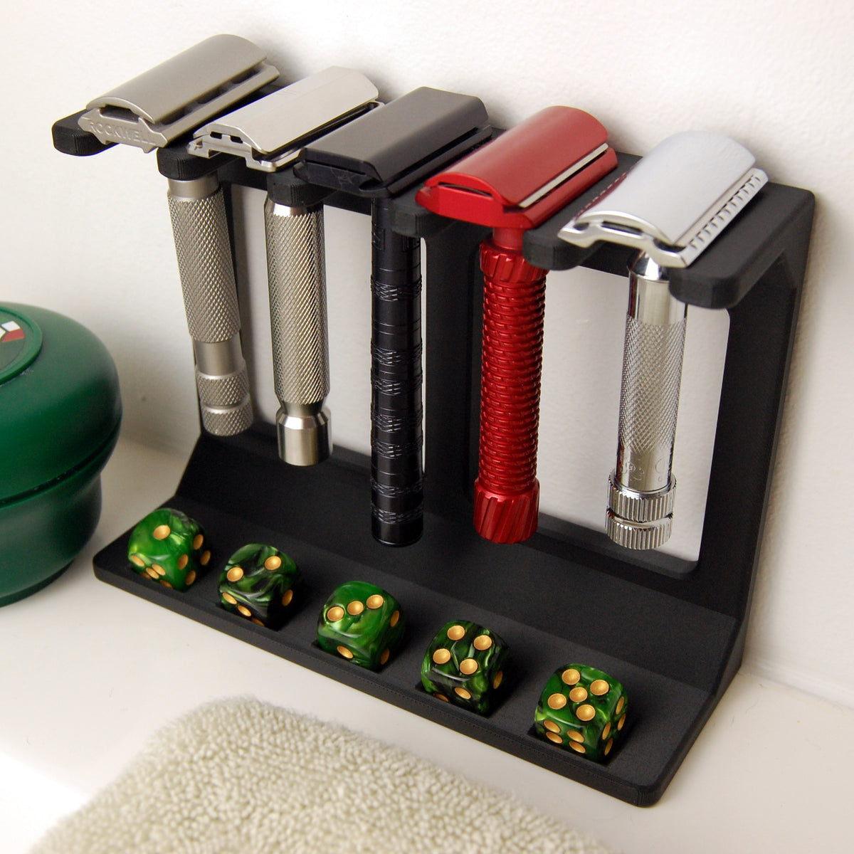 razor garden display stand on a white counter top.  green dice are in the dice slots.