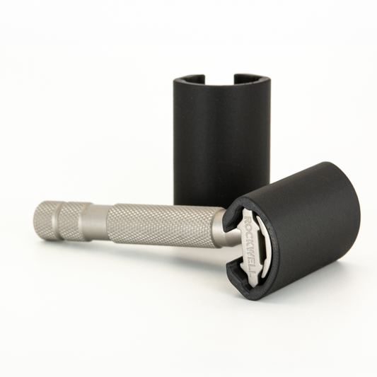 Black Rockwell travel cover slid over the head of a stainless Rockwell 6S, a second cover standing behind