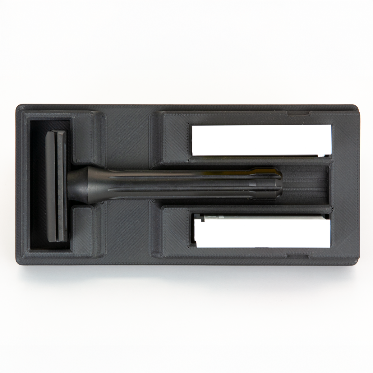 Black Universal Razor Travel Case from above with a black Blackland Blackbird seated in it and two blade boxes alongside