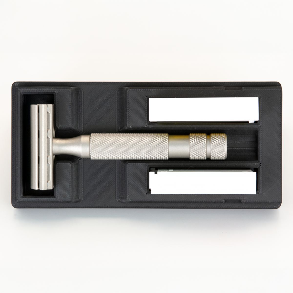 Black Universal Razor Travel Case from above with a stainless Rockwell 6S seated in it and two blade boxes alongside