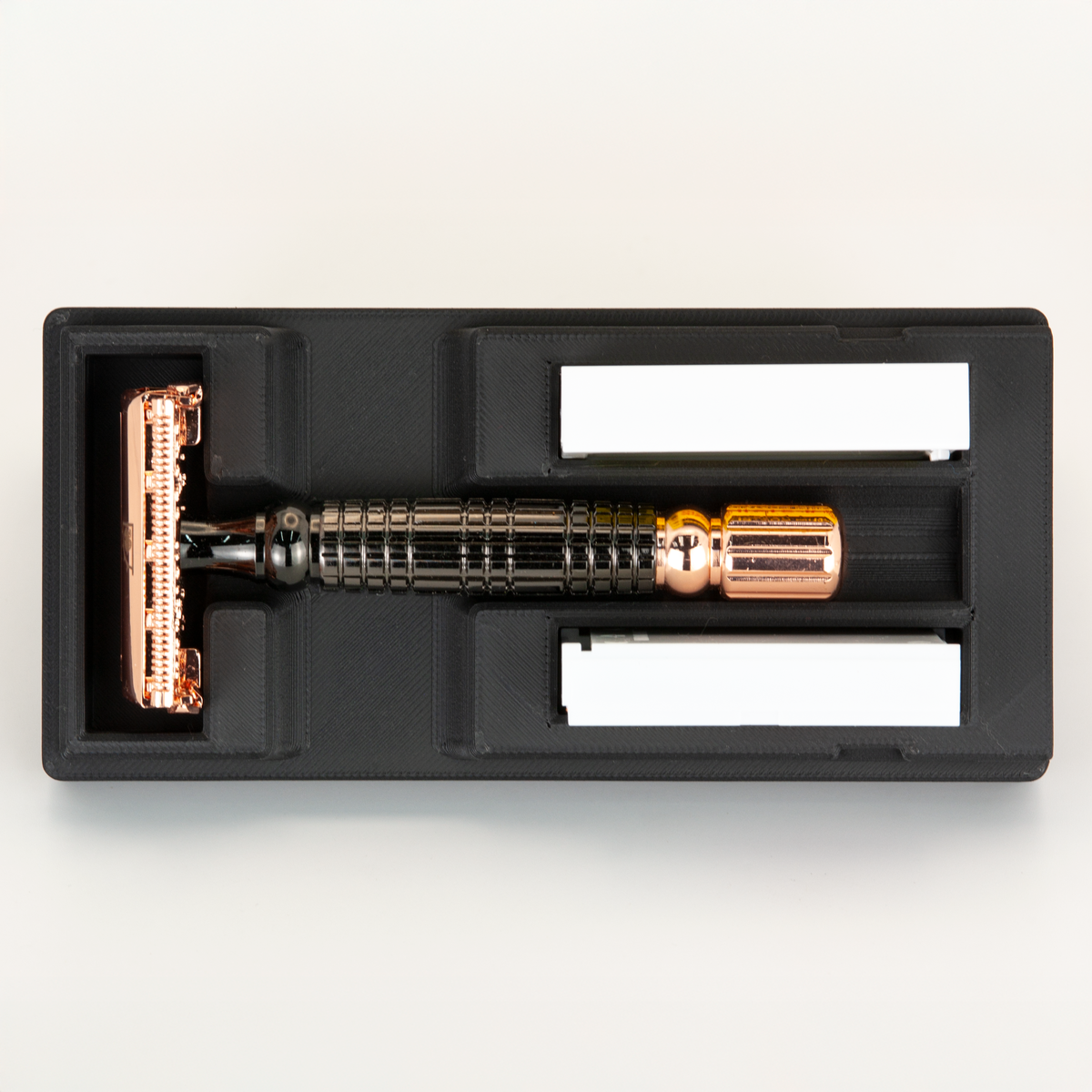 Black Universal Razor Travel Case from above with a rose gold and gunmetal Viking Blade Chieftain seated in it and two blade boxes alongside